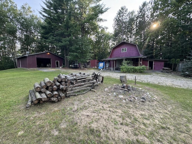 view of yard with a garage and an outbuilding