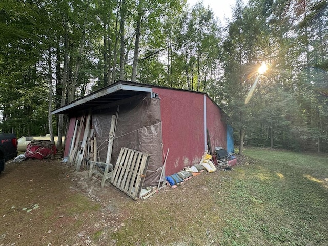 view of outbuilding with a lawn