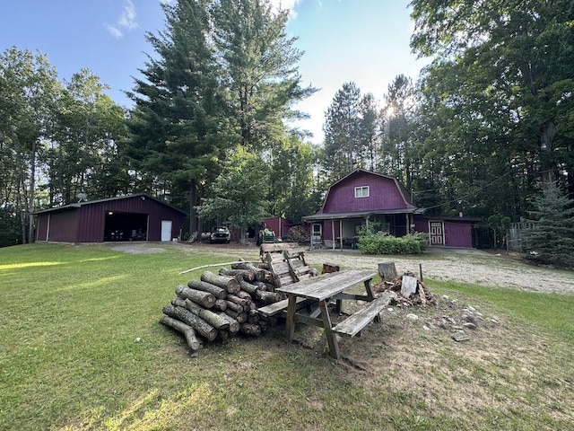 view of yard with a garage and an outdoor structure