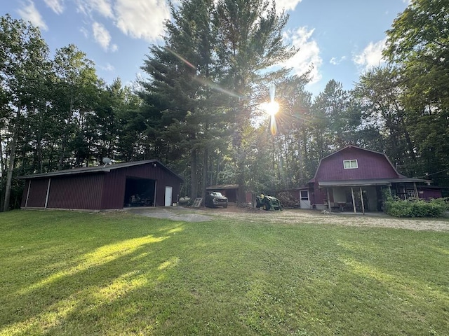 view of yard with a garage and an outdoor structure