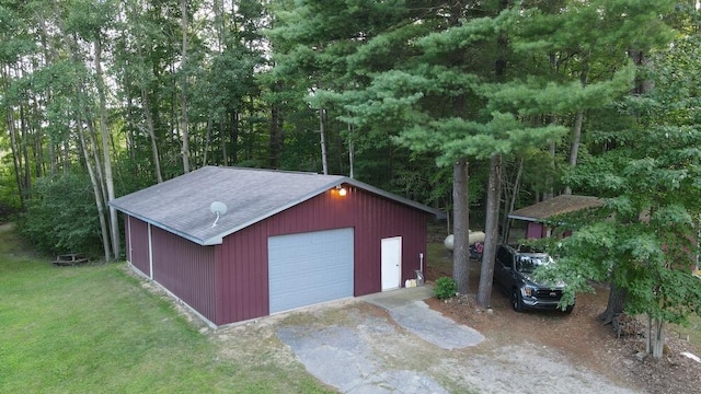 view of outbuilding with a garage and a yard