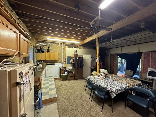 basement with fridge, washing machine and dryer, and heating unit