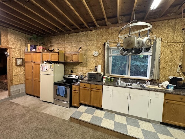 kitchen featuring white refrigerator, sink, and electric range