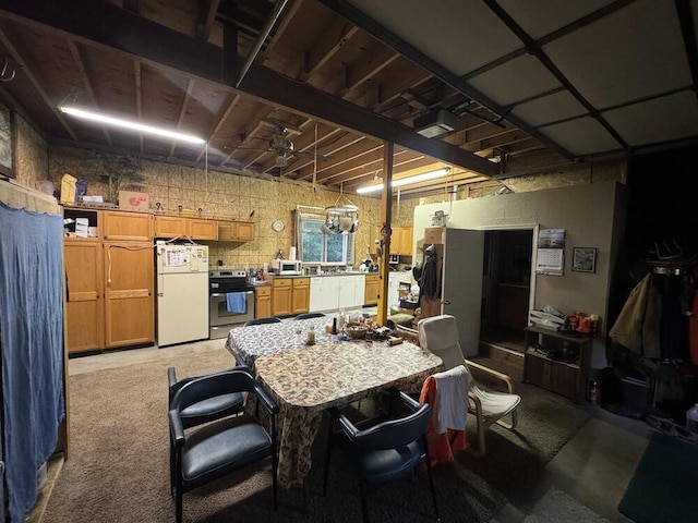 kitchen with electric stove, a breakfast bar area, and white refrigerator