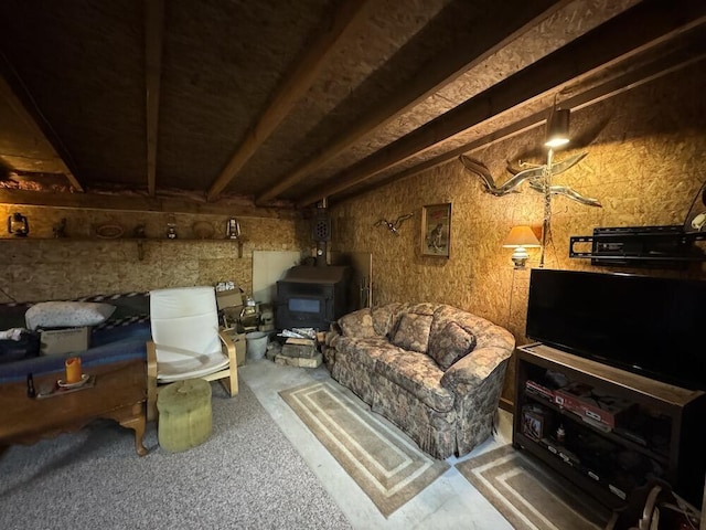 interior space with beamed ceiling and a wood stove