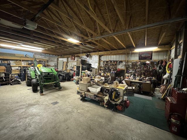 garage with a garage door opener and a workshop area