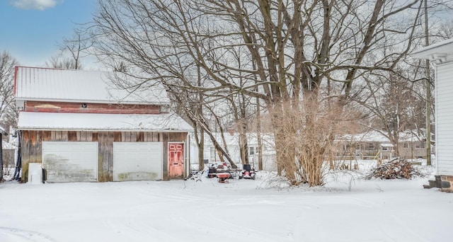 yard covered in snow with a garage