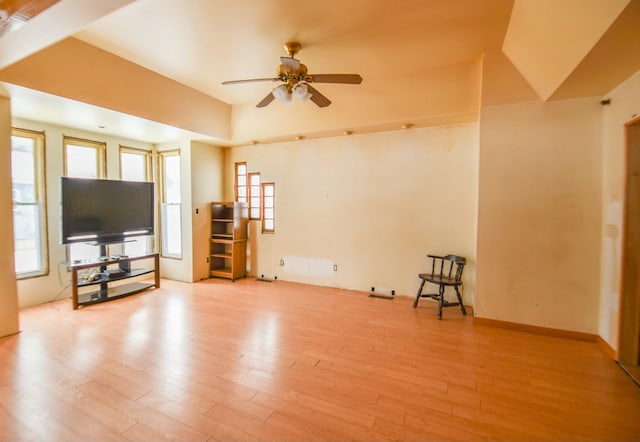 unfurnished living room featuring ceiling fan and light hardwood / wood-style flooring