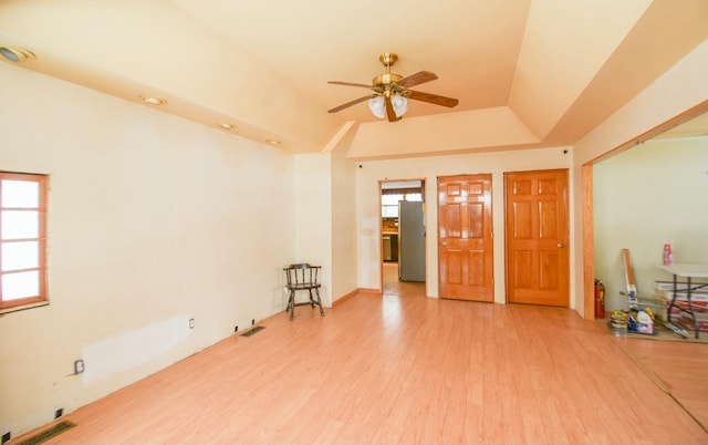 spare room with ceiling fan, wood-type flooring, lofted ceiling, and plenty of natural light