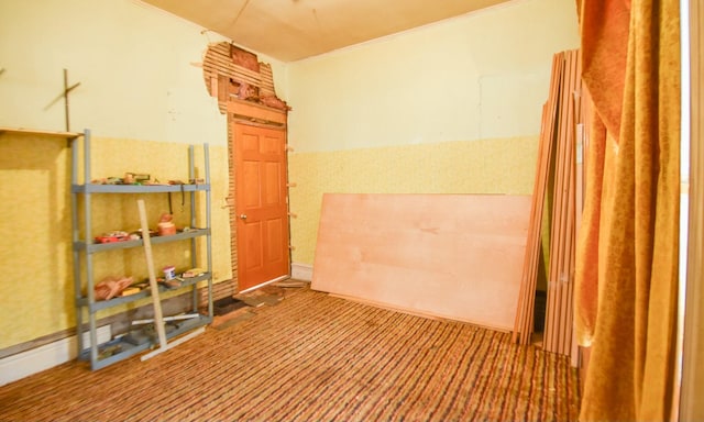 interior space featuring ornamental molding and carpet floors