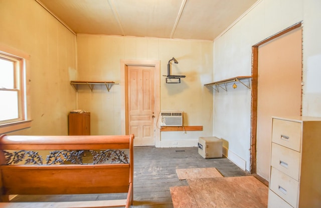 interior space featuring a wall mounted air conditioner and dark hardwood / wood-style flooring