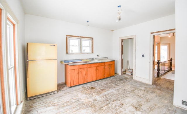 kitchen with fridge and light wood-type flooring