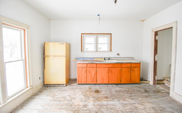 kitchen with light wood-type flooring and white fridge