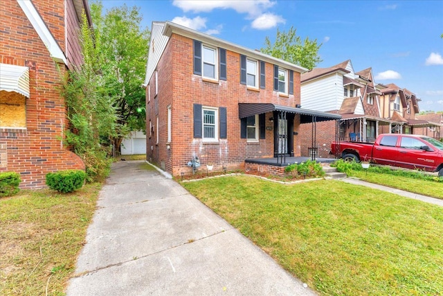 view of front of home with a front yard and covered porch