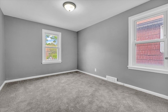 unfurnished room featuring carpet