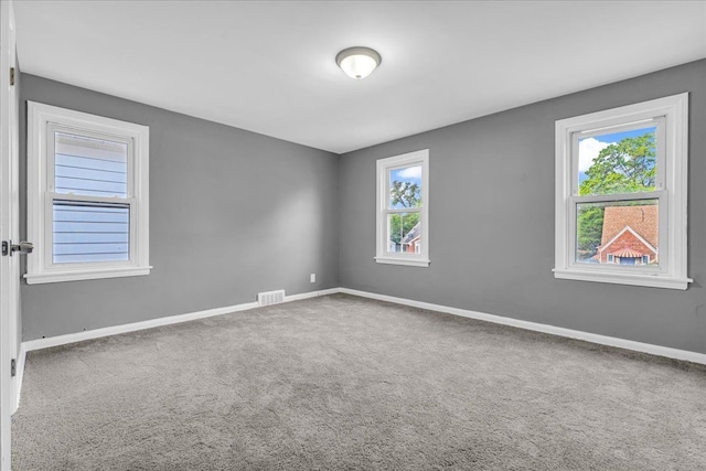 unfurnished room featuring carpet flooring