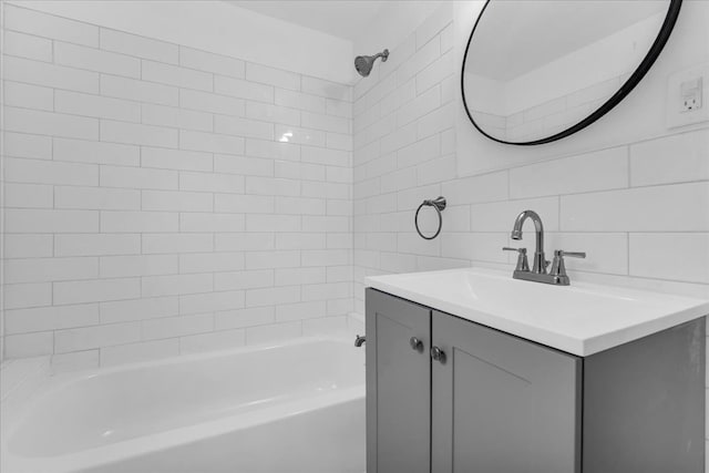 bathroom with vanity, tiled shower / bath combo, decorative backsplash, and tile walls