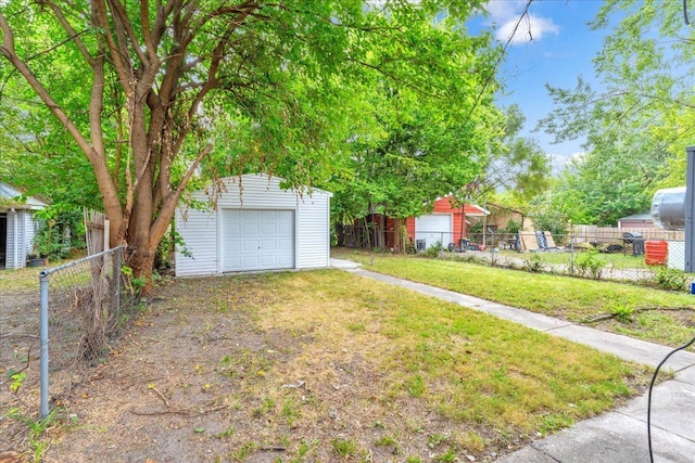 view of yard featuring a garage and an outdoor structure