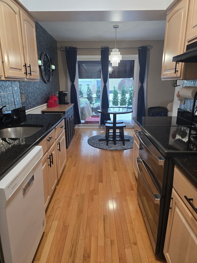 kitchen with sink, decorative light fixtures, light hardwood / wood-style flooring, range with electric stovetop, and white dishwasher