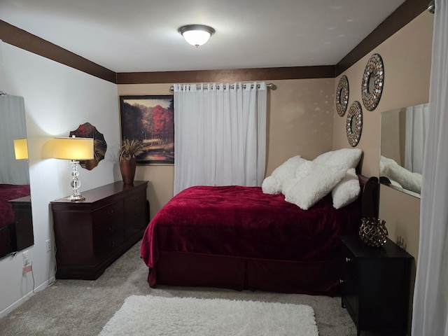 bedroom featuring light carpet