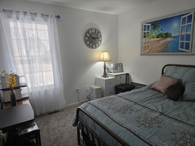 carpeted bedroom with multiple windows