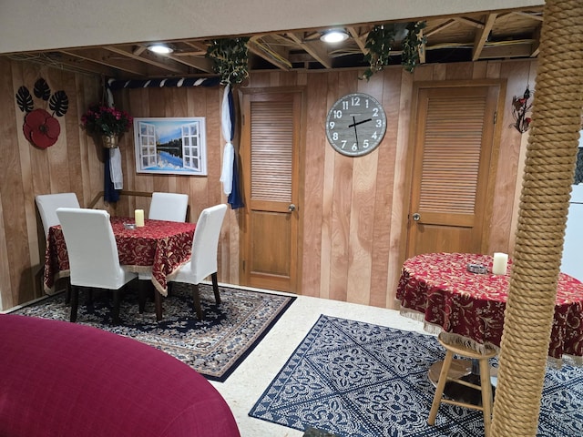 dining space with wood walls