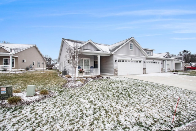 view of front of property featuring a porch, a garage, a lawn, and central air condition unit