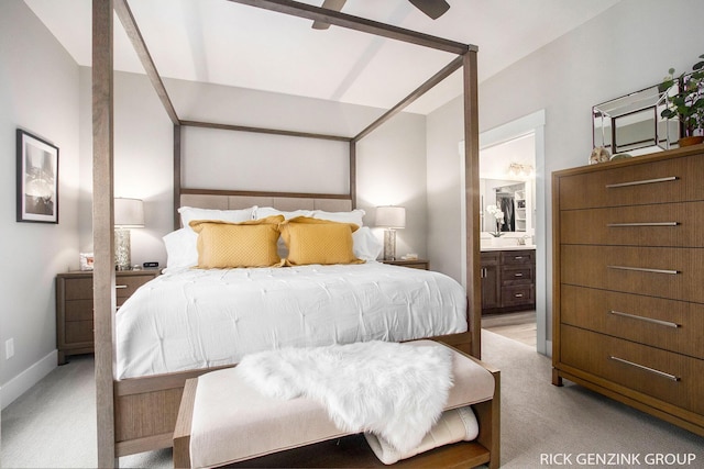 bedroom featuring ceiling fan, ensuite bathroom, and light carpet