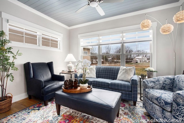 living room with wood ceiling, crown molding, wood-type flooring, and ceiling fan