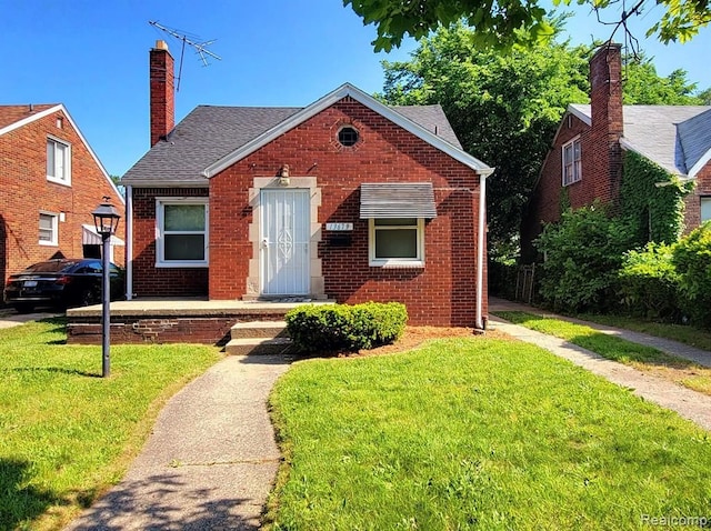 bungalow-style home featuring a front yard