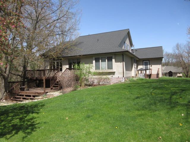 10480 Denton Creek Dr, Fenton, MI 48430 - rear view of property with a lawn and a deck
