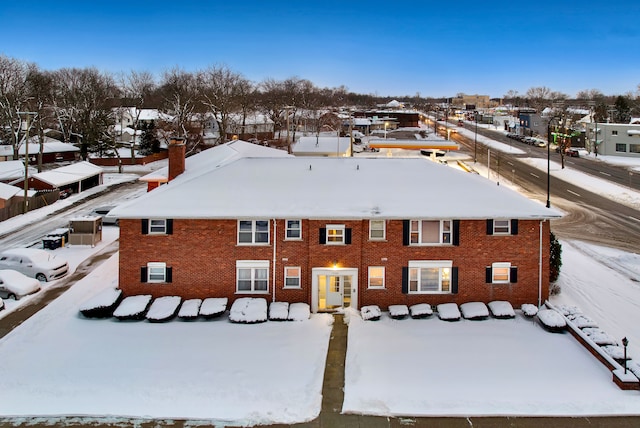 snowy aerial view with a residential view