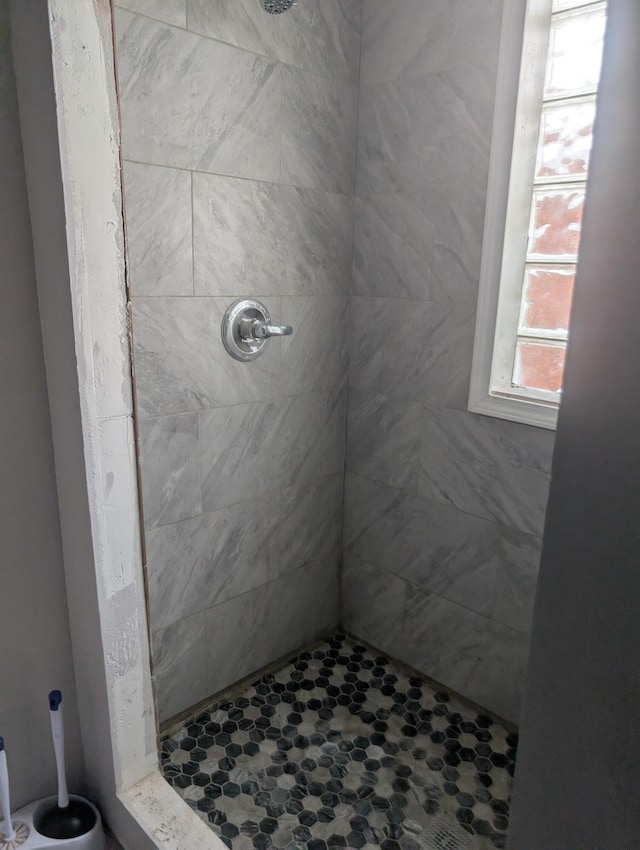 bathroom with tiled shower