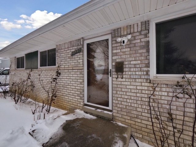 view of snow covered property entrance