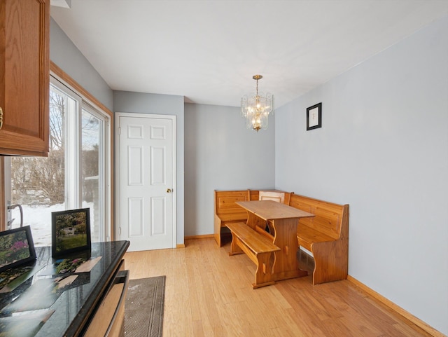 dining space with a chandelier and light hardwood / wood-style floors