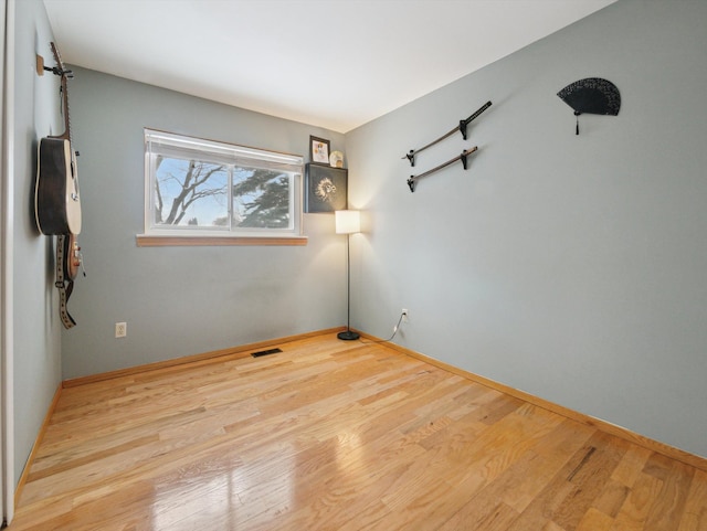 spare room with light hardwood / wood-style flooring