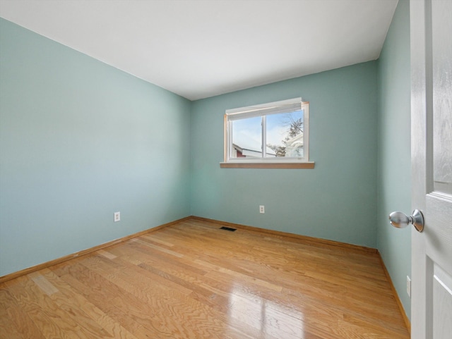 unfurnished room with light hardwood / wood-style flooring