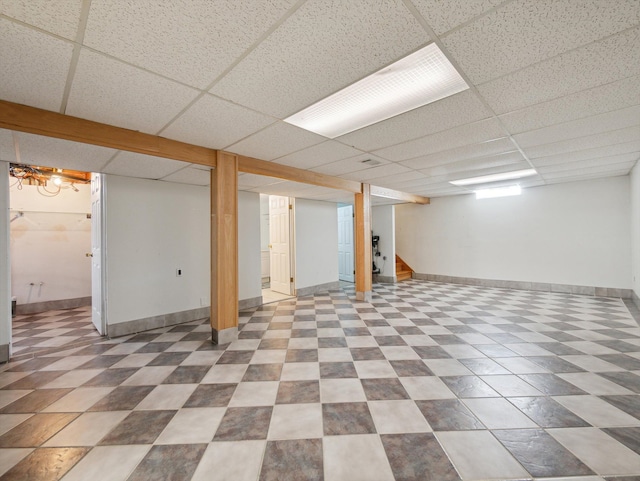 basement with a paneled ceiling