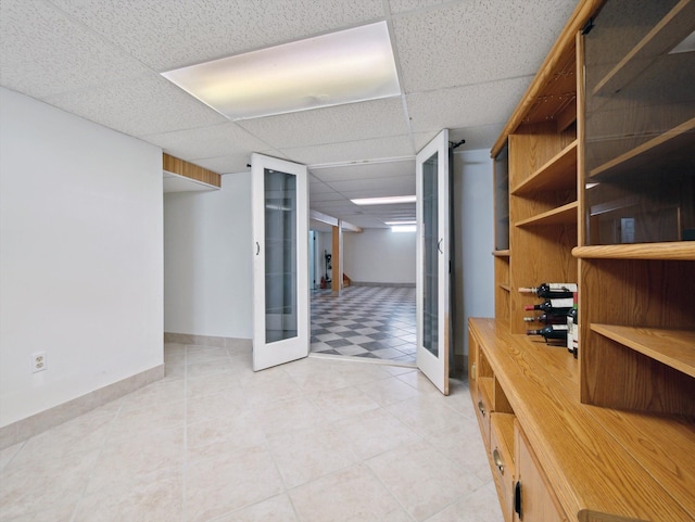 interior space featuring french doors and a paneled ceiling