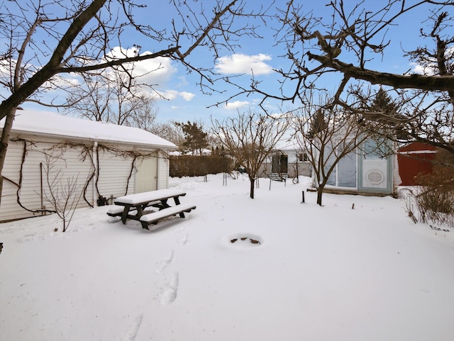 yard covered in snow featuring an outdoor structure