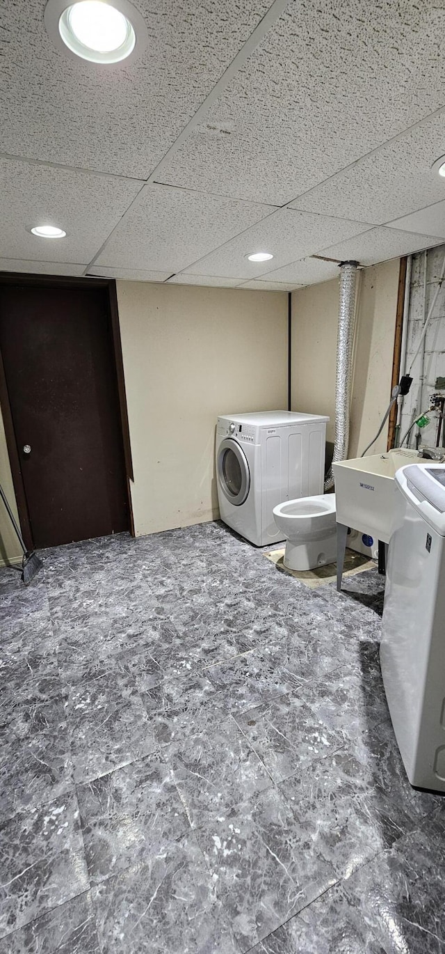 laundry room featuring washing machine and clothes dryer and sink