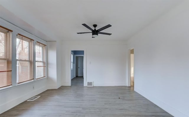 empty room with ceiling fan and light wood-type flooring