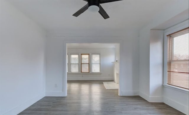 unfurnished room with hardwood / wood-style flooring, a wealth of natural light, and ceiling fan