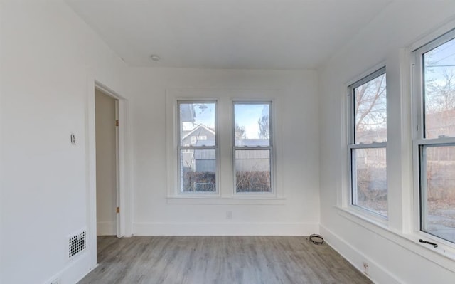 unfurnished room with light hardwood / wood-style floors