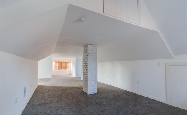 bonus room with decorative columns, vaulted ceiling, and carpet floors