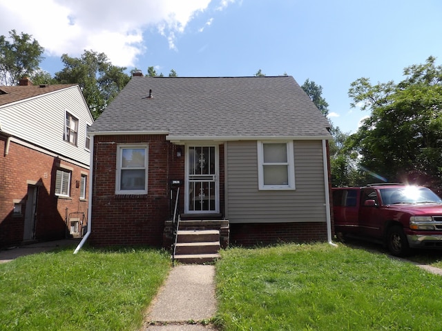 bungalow-style house with a front lawn