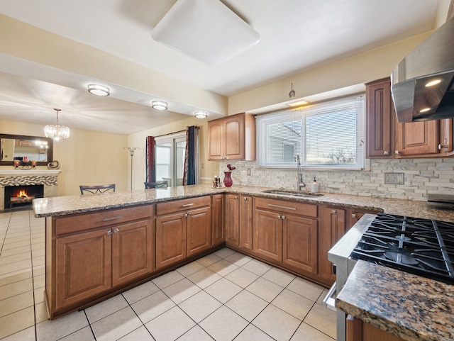 kitchen with light tile patterned floors, sink, ventilation hood, kitchen peninsula, and tasteful backsplash