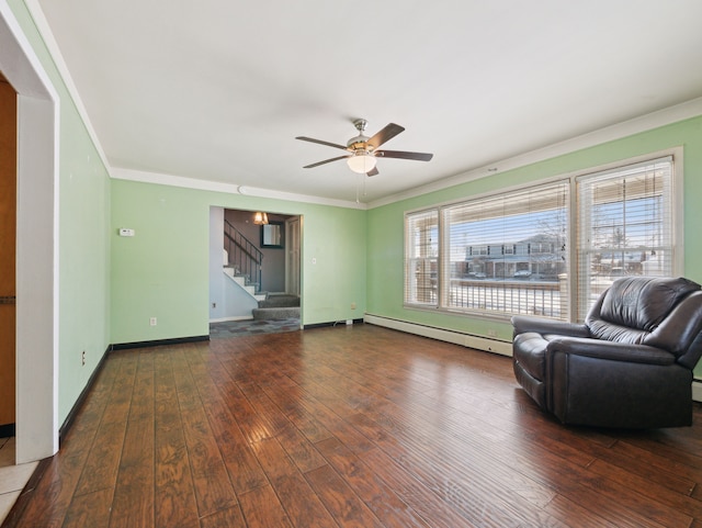 unfurnished room featuring ceiling fan, ornamental molding, dark hardwood / wood-style floors, and a baseboard radiator