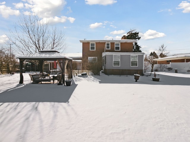 snow covered house with a gazebo