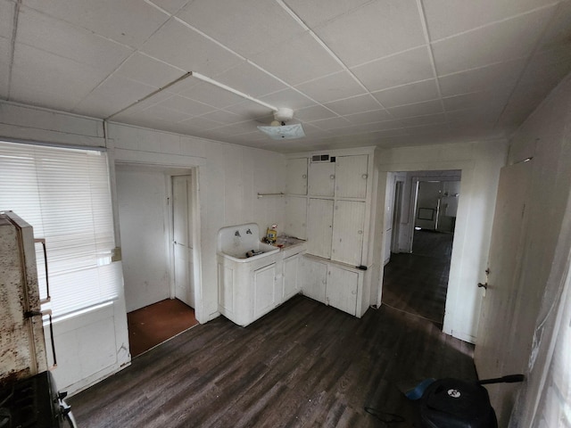 249 Washington Ave, Muskegon, MI 49441 - interior space with visible vents, dark wood-style flooring, and a drop ceiling